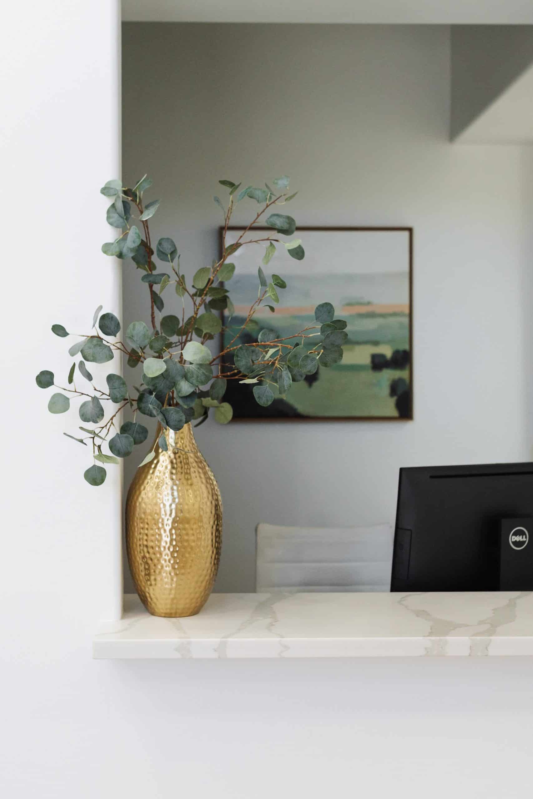 Nice artificial plant in glass vase with gold stainless edge and gold mirror vase and lamp setting | Skin Ritual in Gilbert, Arizona