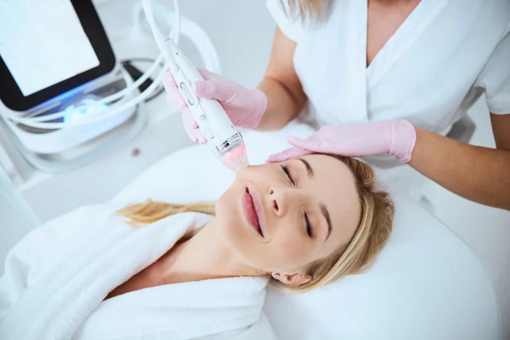 Woman receiving a relaxing Vivace RF microneedling facial treatment from a skincare professional in Gilbert, AZ